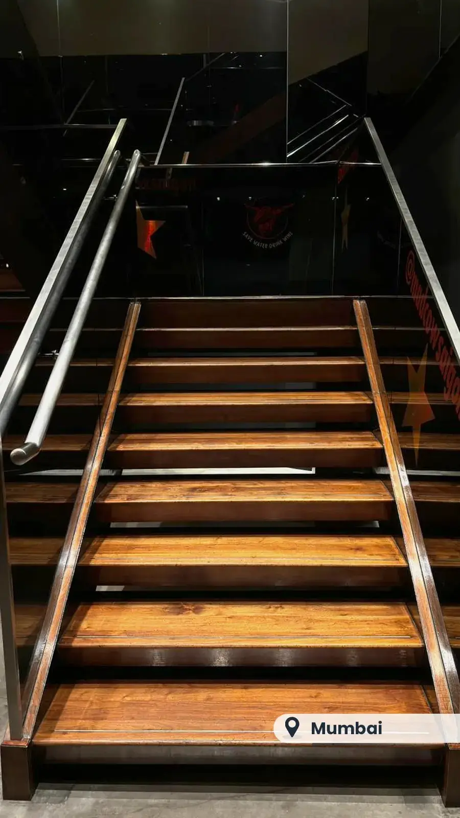 Wide wooden staircase in a restaurant, Mumbai