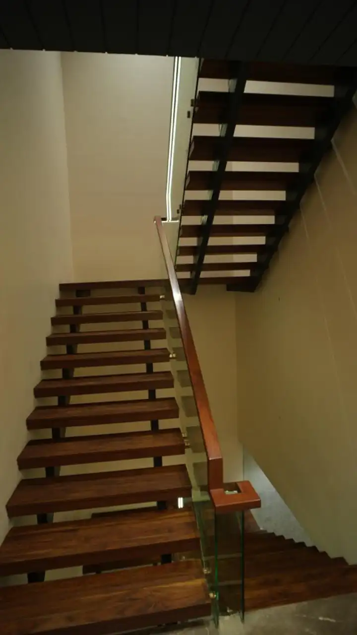 Double flight wooden staircase with glass and timber balustrade