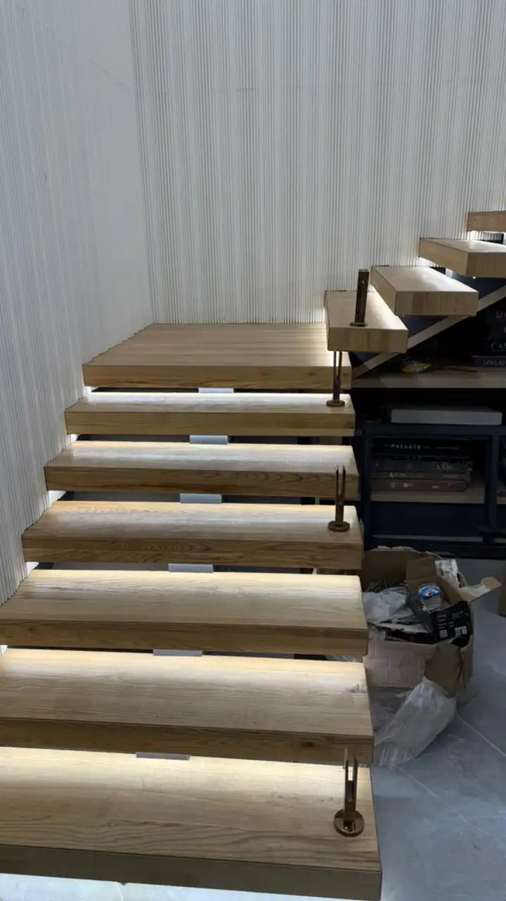 Pale ash treads with concealed lighting under each nosing