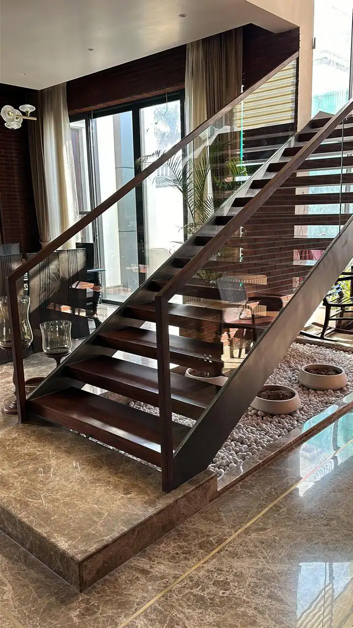 Dark toned solid wood staircase with glass balustrade