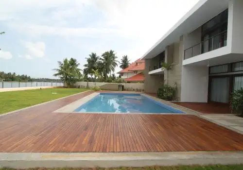 Wooden pool deck beside a waterfront home