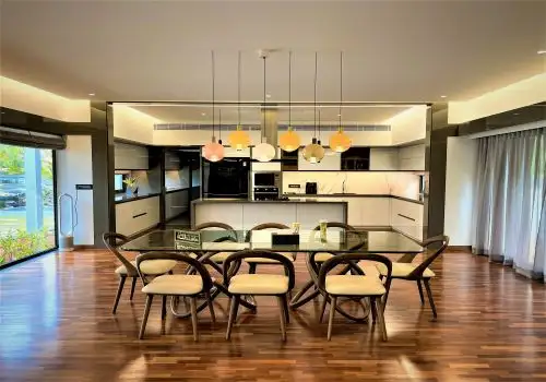 Open plan kitchen and dining over polished wooden flooring