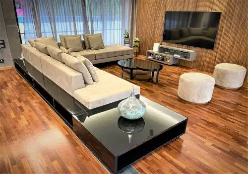 Living room with warm wooden flooring and panelled wall