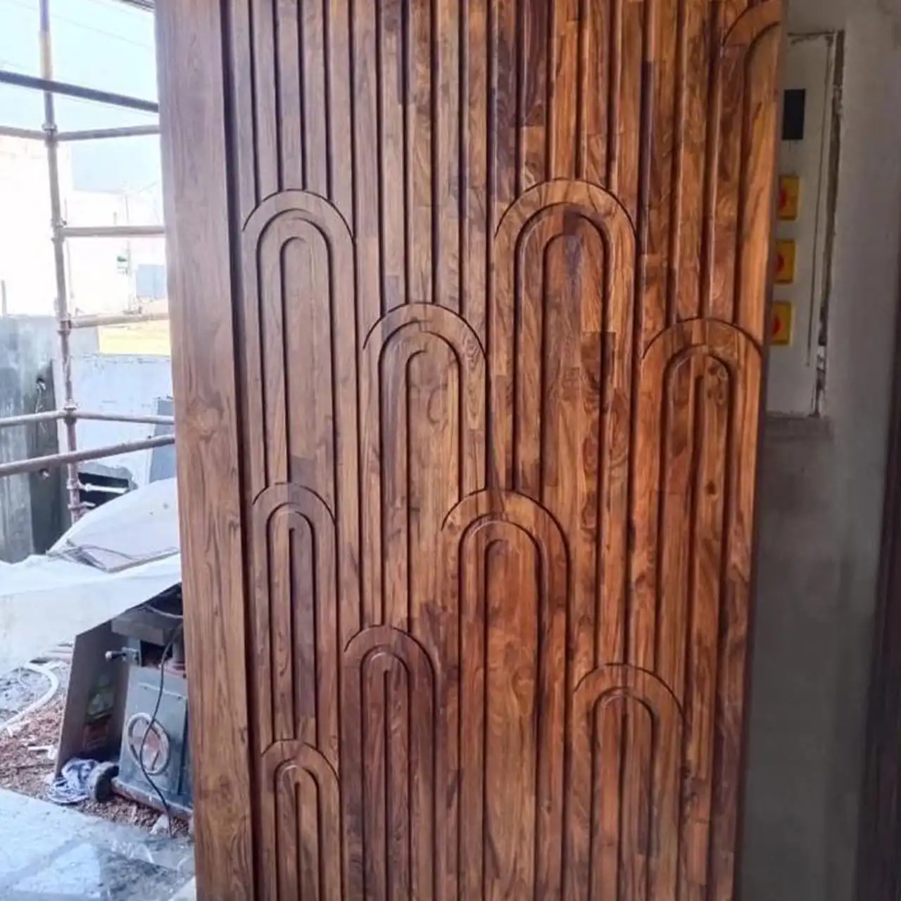 Door panel routed with an arch pattern in teak finger joint board