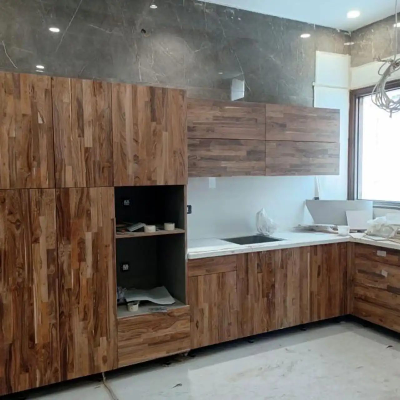 Kitchen cabinetry faced in teak finger joint board